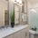 bathroom area with a sink, mirrors, and a stylish faucet
