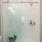 bathroom with white shower tiles and open space
