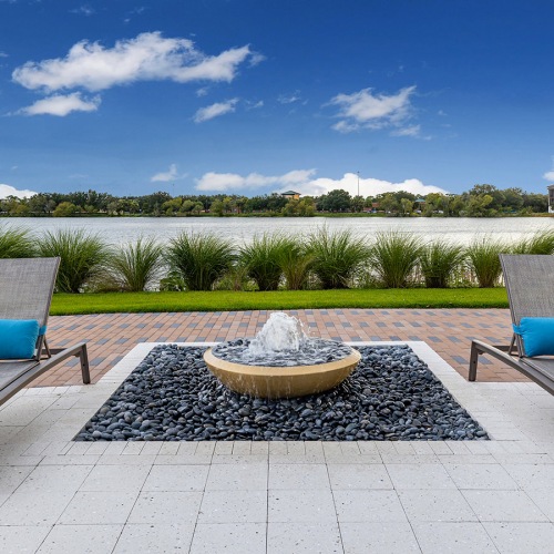 Lounge chairs and fire pit by lake at Ridgelake Apartments in Sarasota, FL Lounge chairs and fire pit by lake at Ridgelake Apartments in Sarasota, FL